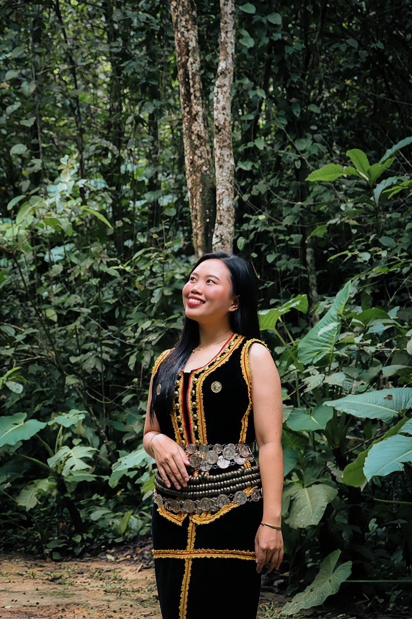 A cultural host in traditional attire in the rainforest